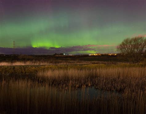 The Northern Lights Or Aurora Borealis Shine Over Great Park In