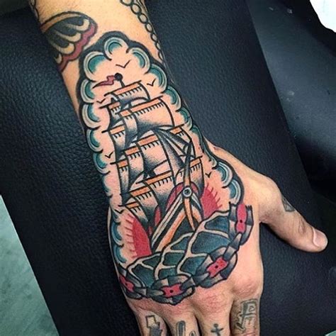 Traditional Style Ship In A Sea Tattoo Inked On The Right Hand And
