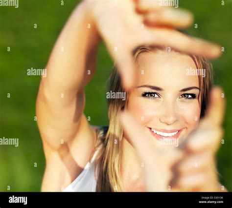 Pretty Girl Having Fun Outdoor Making Frame With Hands Taking Picture