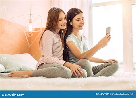 Two Cute Sisters Taking Selfies On Bed Stock Image Image Of Innocent Love 109047013
