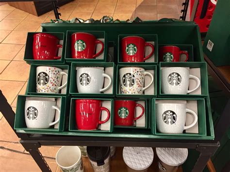 Many Starbucks Mugs Are Arranged In A Green Tray