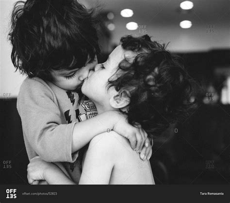 Two Brothers Embrace And Kiss Stock Photo Offset