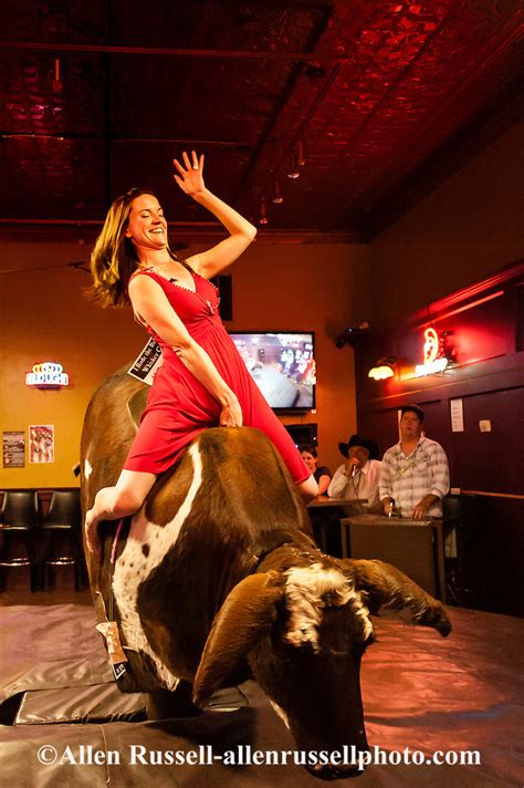 Woman Riding Mechanical Bucking Bull At Livingston Roundup Celebration