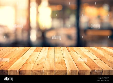 Wood Texture Table Top Counter Bar With Blur Light Gold Bokeh In Cafe