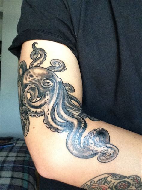 An Octopus Tattoo On The Arm Of A Man