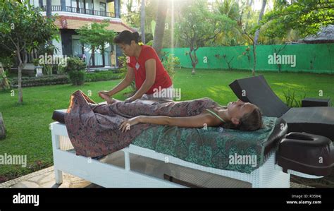 Asian Woman Massage Therapist Doing Massage To Girl Summer Vacation On Luxury Spa Resort