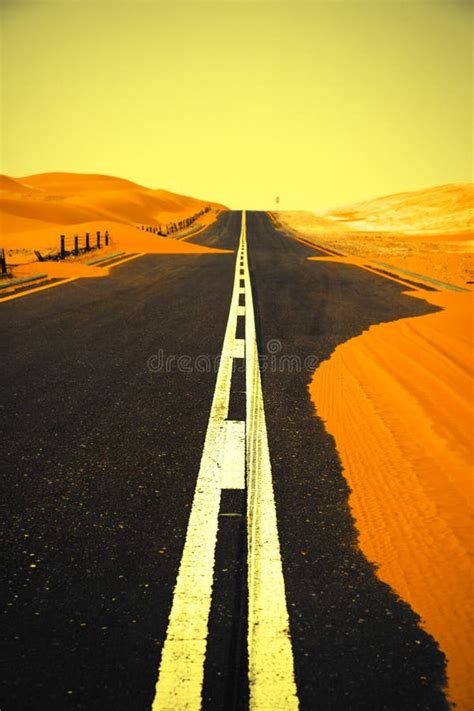 Winding Black Asphalt Road Through The Sand Dunes Of Liwa Oasis United