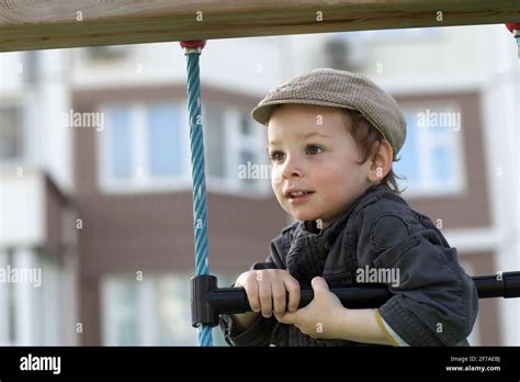 Boy Climbing A Rope Ladder At Playground Stock Photo Alamy