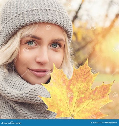 Autumn Portrait Of Young Woman With Autumnal Maple Leaf Outdoors Stock