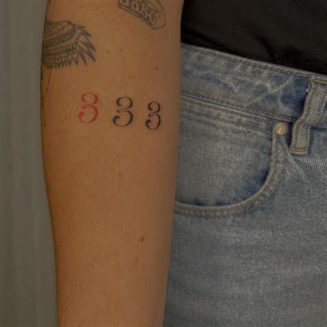 Number 333 Tattooed On The Inner Forearm