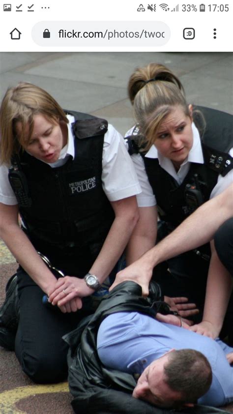 Three Police Officers Helping A Woman On The Ground