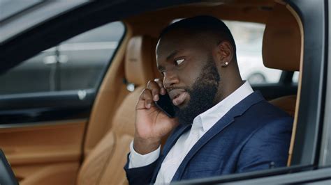 Closeup Serious African Business Man Talking Smartphone At Car