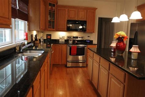 The Kitchen Features Oak Cabinets Dark Granite Counters And Oak