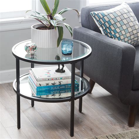 Round glass end tables for living room. Take a simple, unassuming black frame, add tinted glass ...