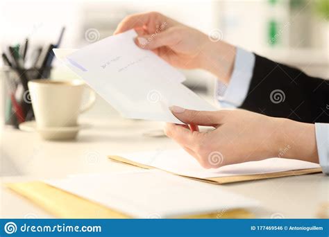 Business Woman Hand Putting Letter On Envelope At The Office Stock