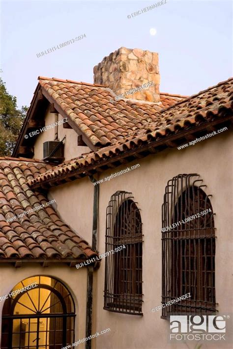 Row Of Windows With Wrought Iron Grills On Side Of Spanish Style Home