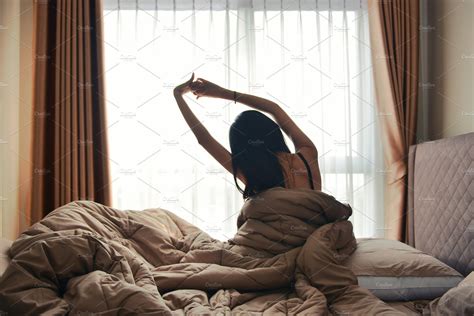 Happy Woman Back View Waking Up Stretching In Bed Room Hotel High