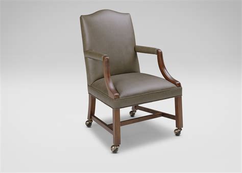The chair is upholstered in paisley fabric with soft shades of green and cream. Clarke Leather Desk Chair - Ethan Allen
