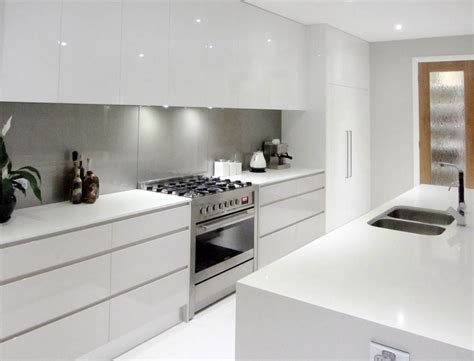 They're glamorous in all the right places, without feeling cold or stark, thanks to stunning wixom door style. White Cupboards, No Handles, Light Grey Splashback, All In ...