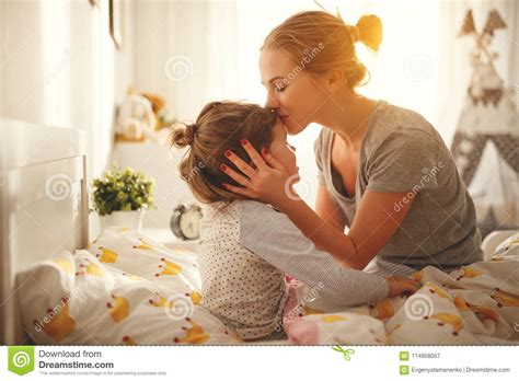 mother wakes her daughter in bed in morning stock image image of lovely embrace 114958057