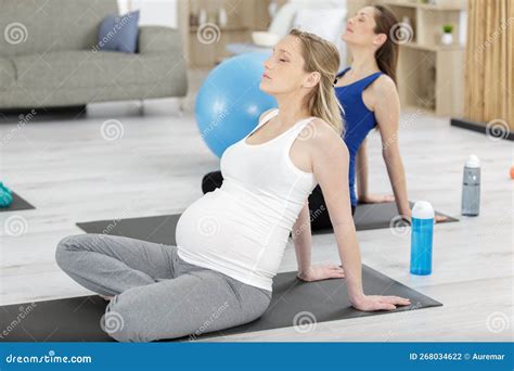 Two Pregnant Women In Antenatal Yoga Class Stock Photo Image Of Floor