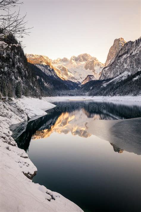 Mountain Lake In Winter With Reflection During Sunset Stock Photo