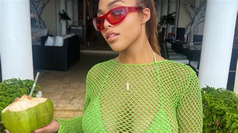 Jordyn Woods Flaunts Her Curves In Neon Green Netted Dress With