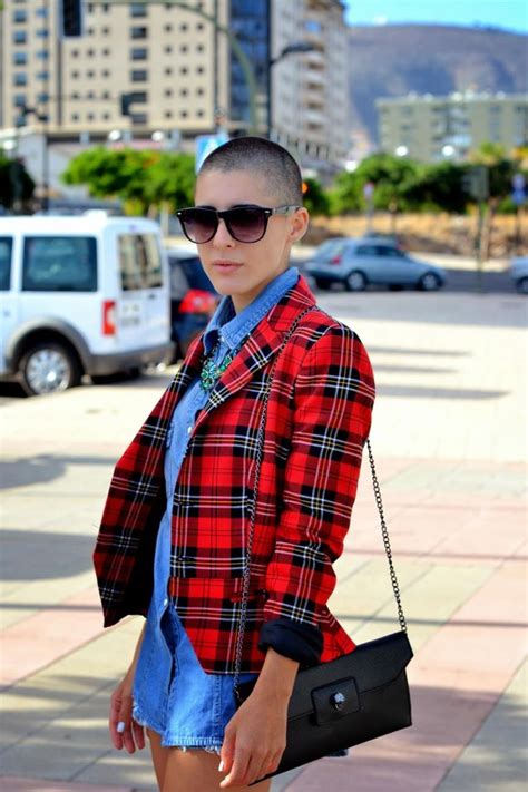 A Woman Wearing Sunglasses And A Red Plaid Jacket