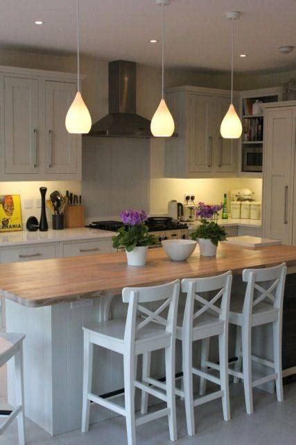 Be sure to leave a suitable distance between the tabletop or island top and the bottom of the fixture. 15 Photo of Lights Over Breakfast Bar