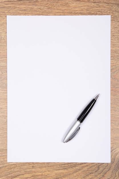 Premium Photo Blank Sheet Of Paper And Pen On Wooden Table