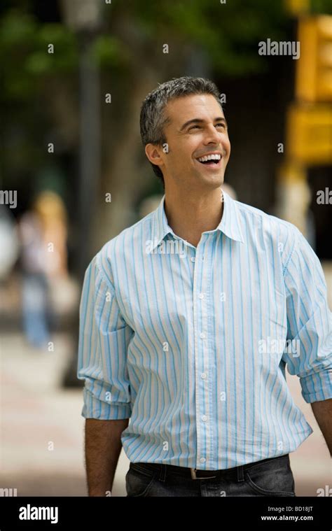 Man Walking Outdoors Smiling Looking Away Stock Photo Alamy