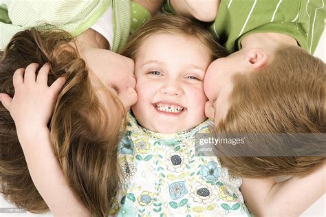 Three Happy Children Playing Kissing Sibblings Smiling Close Up White