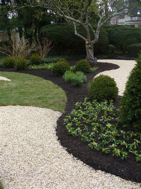 Winter lawn & gardening tips A pairing of black mulch with light colored crushed stone ...