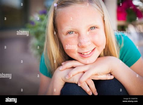Ein Kind Ein Junges Mädchen Sitzt Vornübergebeugt Und Lächelnd Ihr