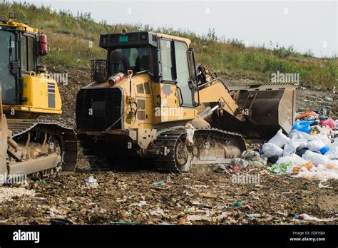Yellow Tractors Work On Dump Household Garbage Waste Sorting On