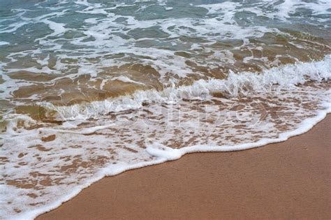 Closeup Detail Of The Foaming Sea Waves Washing Ashore At The Beach