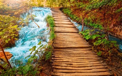 Wooden Path Rocky River With Small Waterfalls Clear Water