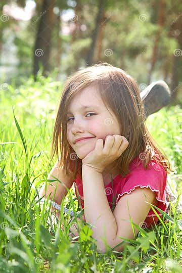 Cute Little Girl Is Lying On Green Meadow Stock Image Image Of Play