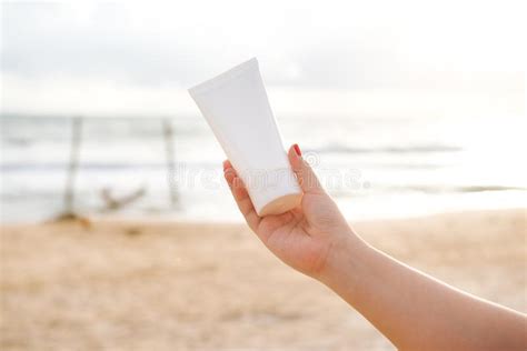 woman holding sunscreen lotion on the beach stock image image of product cream 108305129