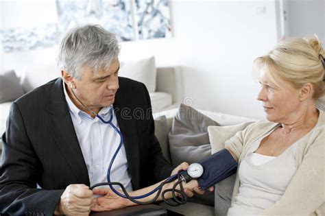 Doctor Taking Blood Pressure To Elderly Woman Stock Photo Image Of