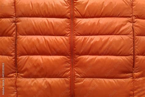 Down Jacket Fabric Background Orange Puffer Jacket Texture Stock Photo
