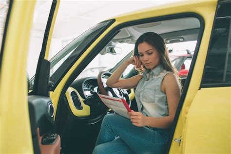 Premium Photo Beautiful Young Woman Buying A Car At Dealership