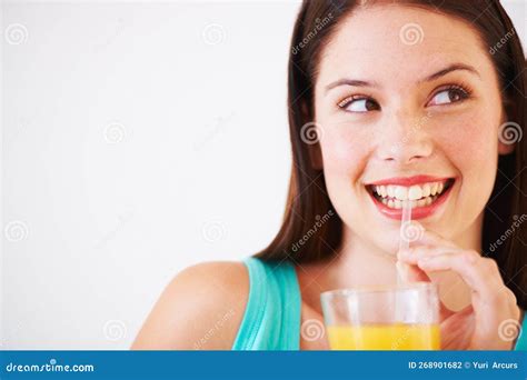 Shes Happy With Her Orange Juice An Attractive Young Woman Looking