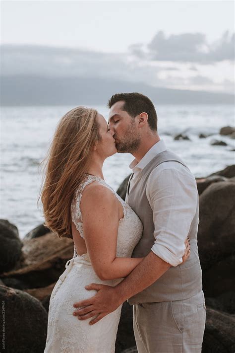 Couple Kissing At Beach Wedding By Stocksy Contributor Leah Flores Stocksy