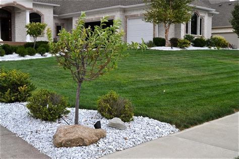 A bright white container near the front door adds some height. marble landscape rock fence - Google Search | Stone landscaping, Gravel landscaping, Landscaping ...