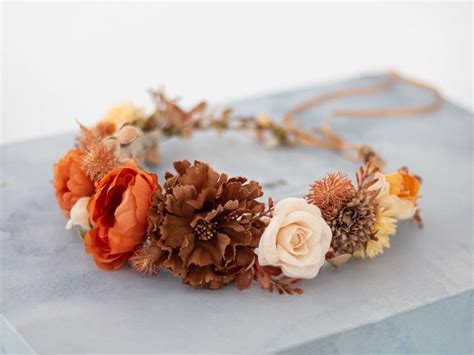 An Orange And White Flower Crown On Top Of A Blue Box