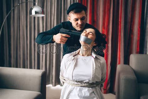 Robber Put The Gun To The Temple Of Female Victim Stock Photo Crushpixel