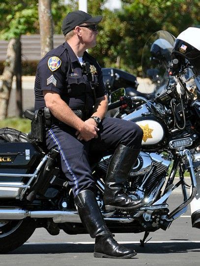 A Police Officer Is Sitting On His Motorcycle