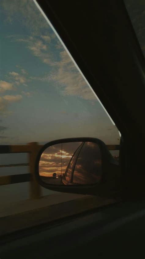 The Rear View Mirror Of A Car As It Is Seen From Inside Another Vehicle
