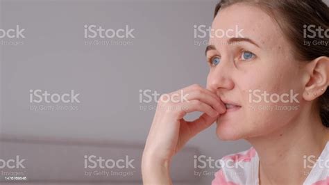 Portrait Of A Nervous Woman Biting Her Nails She Is Upset Unhappy And